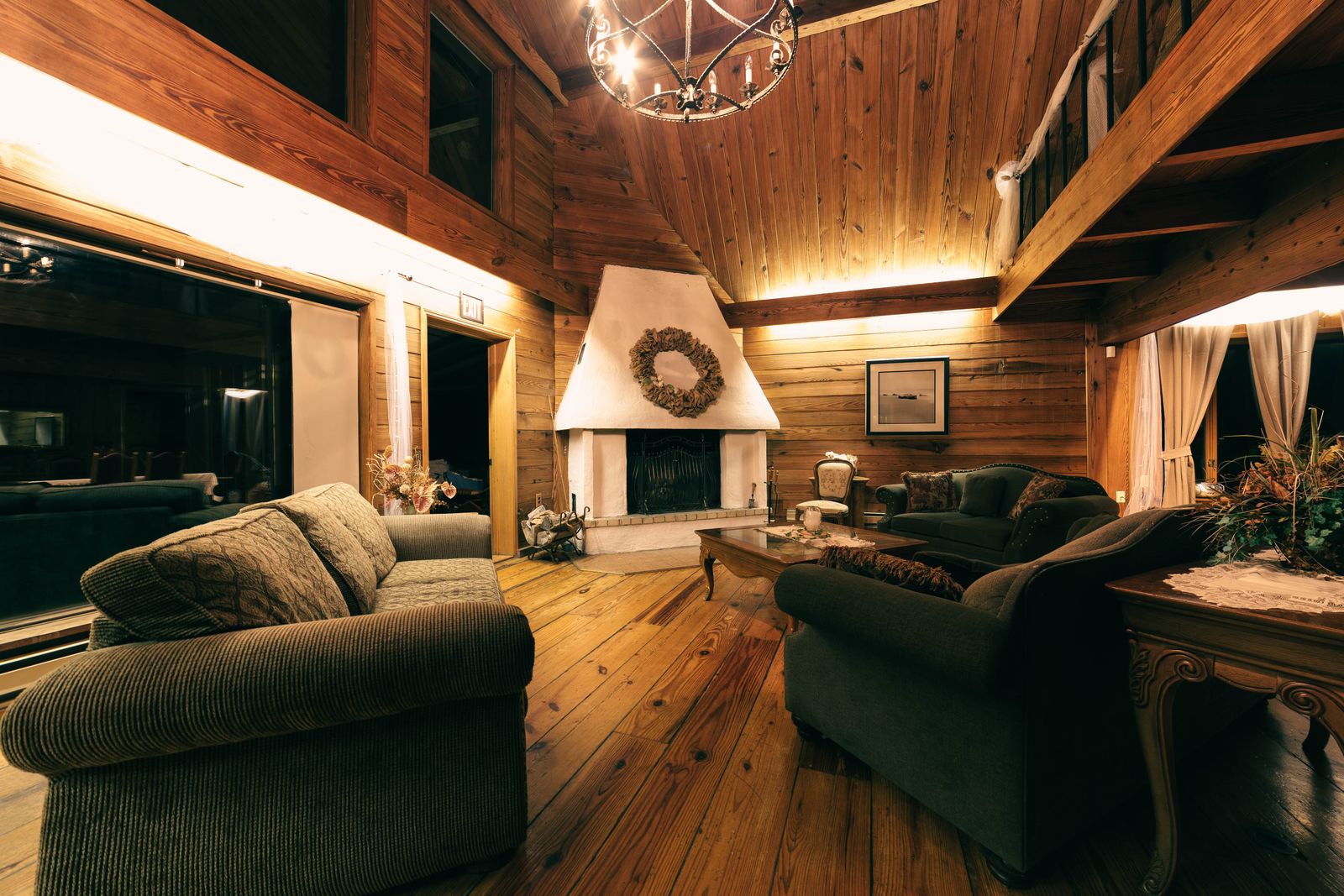 a cosy holiday cottage sitting room with a lit fireplace
