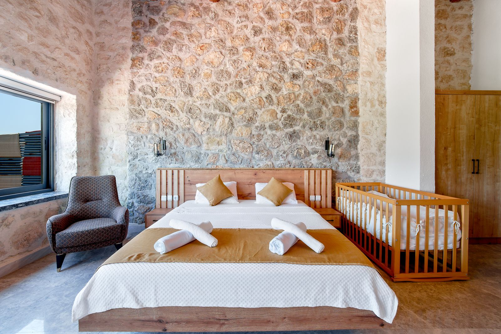a made-up guest bedroom with folded towels, ready for arrival